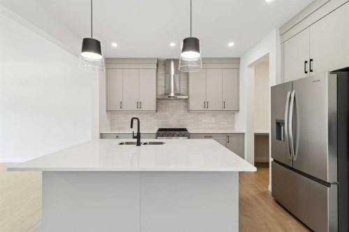 78 Alpine Common Sw, Calgary, AB - Indoor Photo Showing Kitchen With Double Sink With Upgraded Kitchen