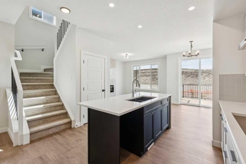 24 Southborough Common, Cochrane, AB - Indoor Photo Showing Kitchen With Double Sink