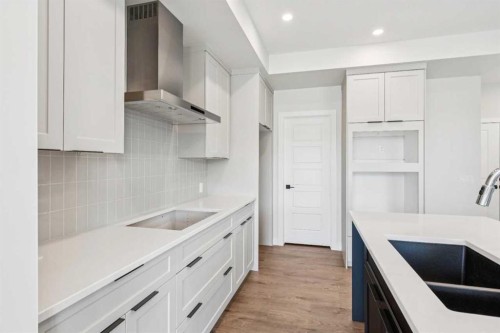 24 Southborough Common, Cochrane, AB - Indoor Photo Showing Kitchen With Double Sink With Upgraded Kitchen