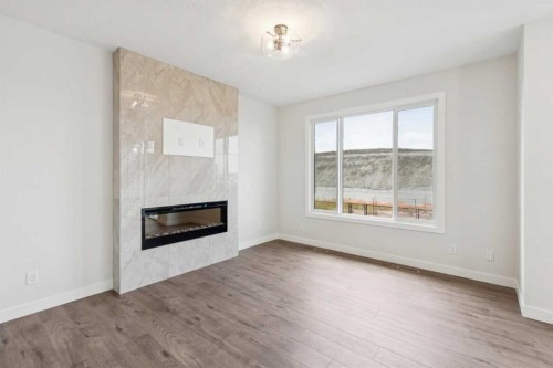 24 Southborough Common, Cochrane, AB - Indoor Photo Showing Living Room With Fireplace
