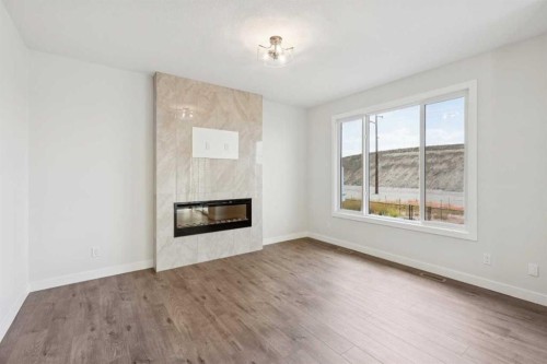 24 Southborough Common, Cochrane, AB - Indoor Photo Showing Living Room With Fireplace