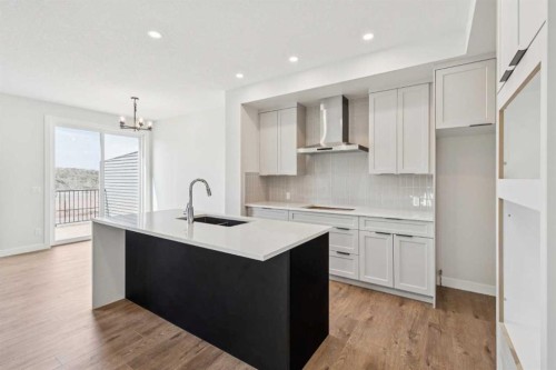 24 Southborough Common, Cochrane, AB - Indoor Photo Showing Kitchen With Upgraded Kitchen