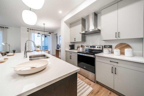 24 Southborough Common, Cochrane, AB - Indoor Photo Showing Kitchen With Double Sink With Upgraded Kitchen