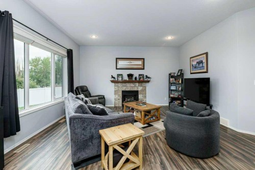 9 Henner'S Outlook, Lacombe, AB - Indoor Photo Showing Living Room With Fireplace