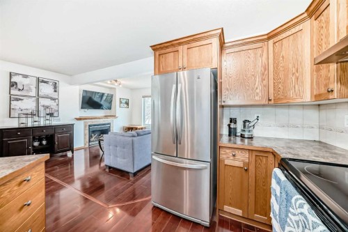 102-6220 Orr Drive, Red Deer, AB - Indoor Photo Showing Kitchen With Fireplace