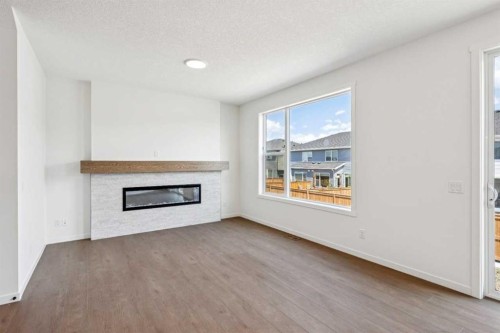 28 Southborough Bay, Cochrane, AB - Indoor Photo Showing Living Room With Fireplace