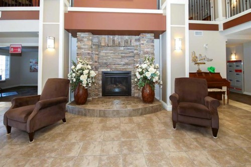 227-6 Michener Boulevard, Red Deer, AB - Indoor Photo Showing Living Room With Fireplace