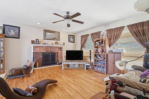 4420 57 Avenue, Innisfail, AB - Indoor Photo Showing Living Room With Fireplace