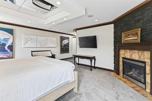 4552 Waskasoo Crescent, Red Deer, AB - Indoor Photo Showing Bedroom With Fireplace