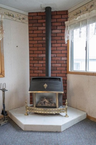 #8 48A Street Close, Alix, AB - Indoor Photo Showing Other Room With Fireplace