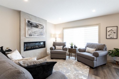 22 Napoleon Meadows Way, Innisfail, AB - Indoor Photo Showing Living Room With Fireplace