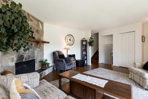 4003 53 Avenue, Innisfail, AB - Indoor Photo Showing Living Room With Fireplace
