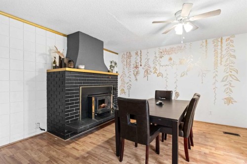 5224 50 Avenue, Sylvan Lake, AB - Indoor Photo Showing Dining Room With Fireplace