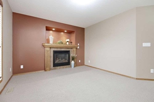 15 Reynolds Road, Sylvan Lake, AB - Indoor Photo Showing Living Room With Fireplace