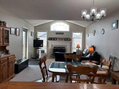 58 Logan Close, Red Deer, AB - Indoor Photo Showing Dining Room With Fireplace