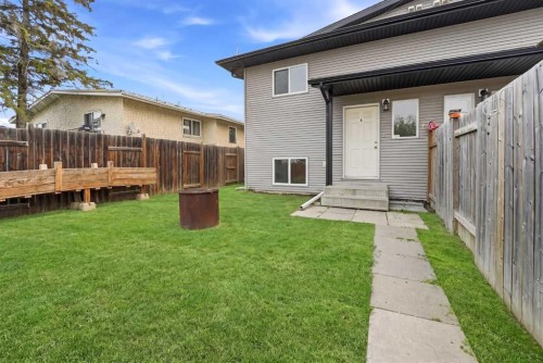 A-1205 Fleming Avenue, Penhold, AB - Outdoor With Deck Patio Veranda With Exterior