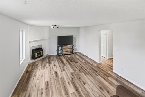 171 Douglas Avenue, Red Deer, AB - Indoor Photo Showing Living Room With Fireplace