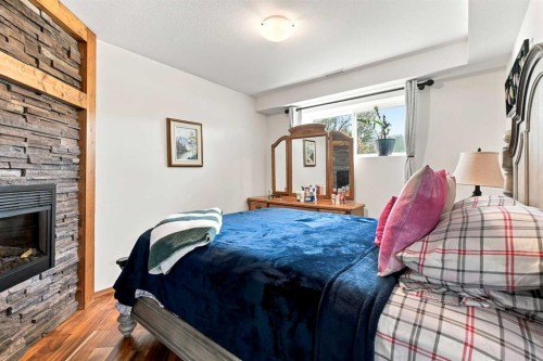 118 Oak Drive, Red Deer, AB - Indoor Photo Showing Bedroom With Fireplace