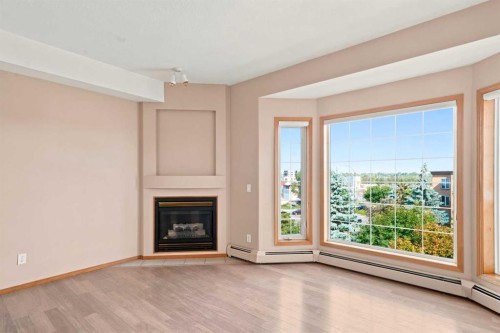 412-4512 52 Avenue, Red Deer, AB - Indoor Photo Showing Living Room With Fireplace