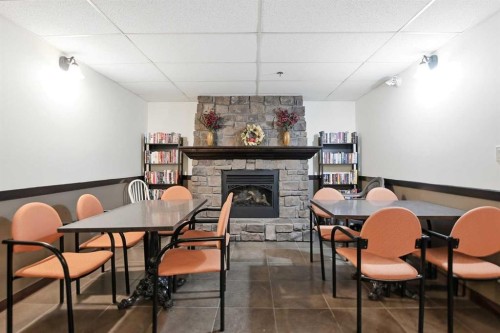 412-69 Ironstone Drive, Red Deer, AB - Indoor Photo Showing Dining Room With Fireplace
