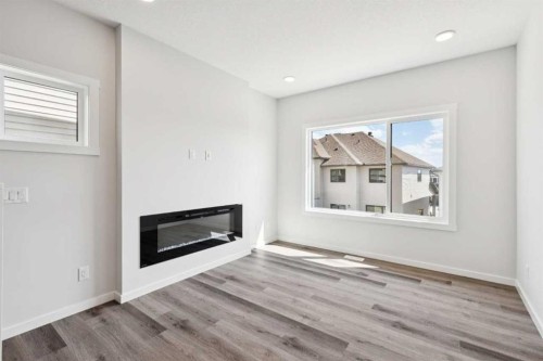 386 Heritage Boulevard, Cochrane, AB - Indoor Photo Showing Living Room With Fireplace
