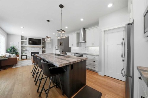 110 Longmire Close, Red Deer, AB - Indoor Photo Showing Kitchen With Fireplace With Stainless Steel Kitchen With Double Sink With Upgraded Kitchen