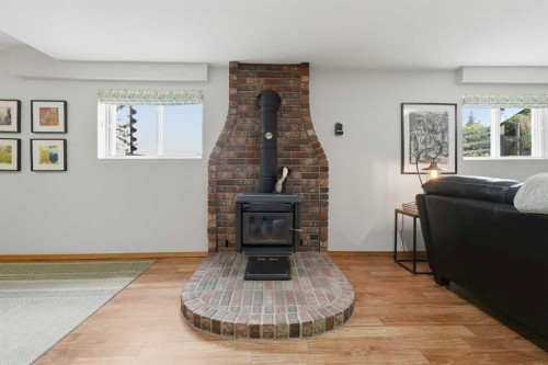 37 Wildrose Street, Rural Lacombe County, AB - Indoor Photo Showing Living Room With Fireplace