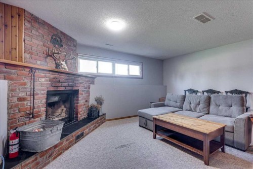 43 Oak Street, Red Deer, AB - Indoor Photo Showing Living Room With Fireplace