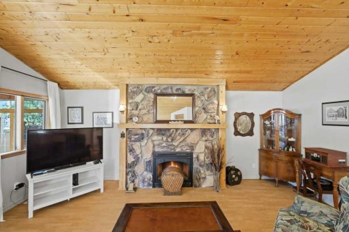 5127 50 A Avenue, Sylvan Lake, AB - Indoor Photo Showing Living Room With Fireplace