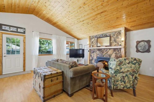 5127 50 A Avenue, Sylvan Lake, AB - Indoor Photo Showing Living Room With Fireplace