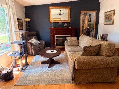 5412 49 A Avenue, Alix, AB - Indoor Photo Showing Living Room With Fireplace