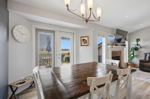 70 Rozier Close, Sylvan Lake, AB - Indoor Photo Showing Dining Room With Fireplace