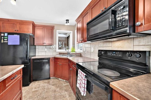 59 Lodge Place, Sylvan Lake, AB - Indoor Photo Showing Kitchen With Double Sink