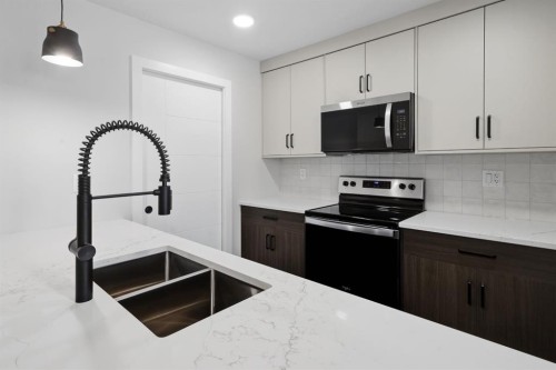 20 Toye Street, Red Deer, AB - Indoor Photo Showing Kitchen With Double Sink