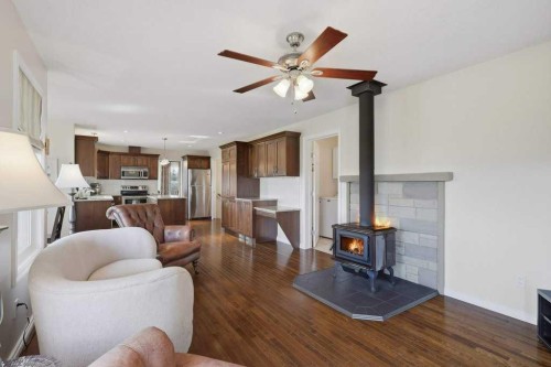 430057 Range Road 22, Rural Ponoka County, AB - Indoor Photo Showing Living Room With Fireplace
