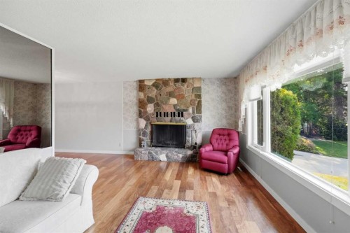 8 Sydney Close, Red Deer, AB - Indoor Photo Showing Living Room With Fireplace