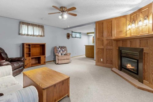 4732 48 Street, Sylvan Lake, AB - Indoor Photo Showing Living Room With Fireplace