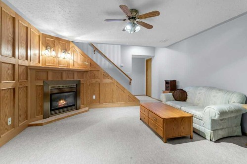 4732 48 Street, Sylvan Lake, AB - Indoor Photo Showing Living Room With Fireplace