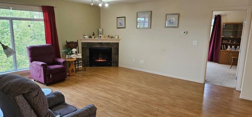 406-4425 Heritage Way, Lacombe, AB - Indoor Photo Showing Living Room With Fireplace
