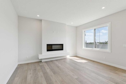 162 Drystone Way Nw, Calgary, AB - Indoor Photo Showing Living Room With Fireplace
