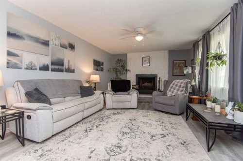 4606 51 Avenue, Bentley, AB - Indoor Photo Showing Living Room With Fireplace