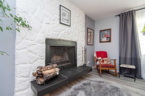 4606 51 Avenue, Bentley, AB - Indoor Photo Showing Living Room With Fireplace