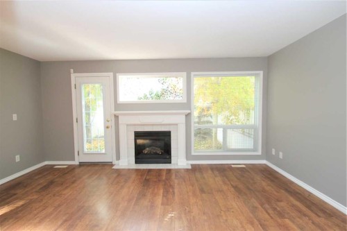 52-73 Addington Drive, Red Deer, AB - Indoor Photo Showing Living Room With Fireplace