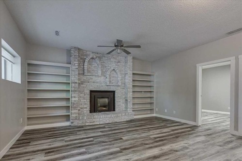134 Douglas Avenue, Red Deer, AB - Indoor Photo Showing Other Room With Fireplace