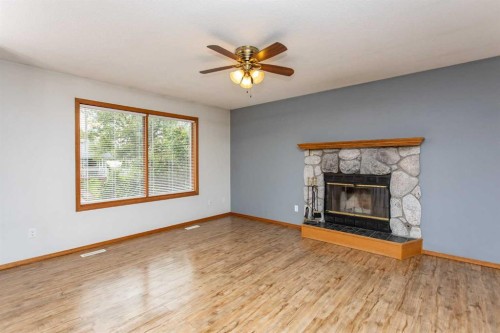 22 Bruns Crescent, Lacombe, AB - Indoor Photo Showing Living Room With Fireplace