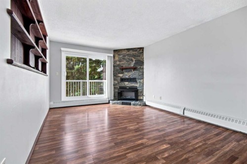 305-71 Cosgrove Crescent, Red Deer, AB - Indoor Photo Showing Living Room With Fireplace