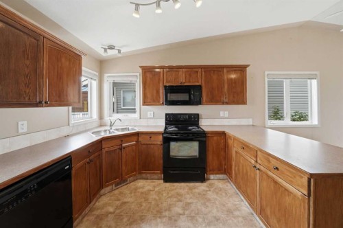 84 Heartland Crescent, Penhold, AB - Indoor Photo Showing Kitchen With Double Sink