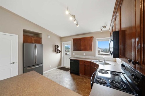 84 Heartland Crescent, Penhold, AB - Indoor Photo Showing Kitchen With Double Sink