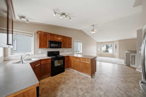 84 Heartland Crescent, Penhold, AB - Indoor Photo Showing Kitchen With Double Sink