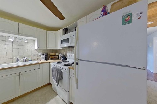 5115 48 Avenue, Sylvan Lake, AB - Indoor Photo Showing Kitchen With Double Sink